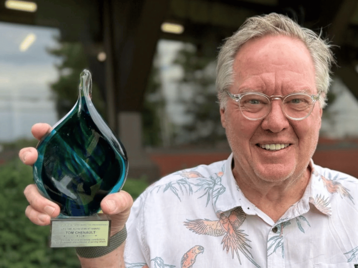 Tom Chenault holding his ANMP Lifetime Achievement Award